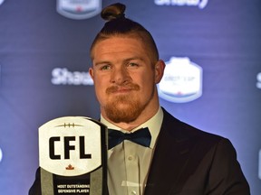 Winnipeg Blue Bombers linebacker Adam Bighill holding up his Most Outstanding Defensive Player award at the CFL Awards Gala in Edmonton, November 22, 2018. Ed Kaiser/Postmedia