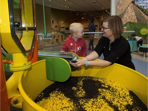 Nancy Thomas, assistant professor of early learning and child care at MacEwan University, plays with Hudson Heagle, 3, at the Big Machine in the Royal Alberta Museum's Children's Gallery. Greg Southam/Postmedia