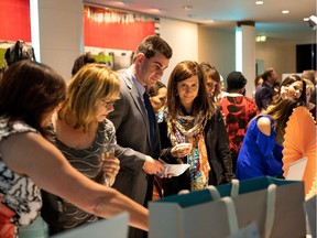 People check out the silent auction during the Fashion with Compassion Gala at the Shaw Conference Centre on Thursday, Oct. 25.