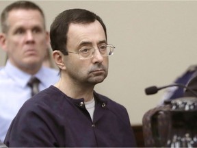 In this Jan. 24, 2018, file photo, Larry Nassar, a former doctor for USA Gymnastics and member of Michigan State's sports medicine staff, sits in court during his sentencing hearing in Lansing, Mich.