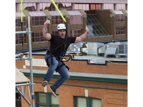 Jesse Perry bungee jumps at the Grey Cup street festival , on Thursday, Nov. 22, 2018, in Edmonton.