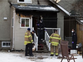 Fire investigators inspect the aftermath of a fire at 11164 97 St. that occurred on Thursday, Nov. 29, 2018, in Edmonton.