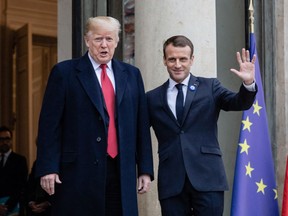 President Donald Trump, left, and French President Emmanuel Macron meet at the Elysee Palace during World War I commemoration ceremonies in Paris on Saturday.