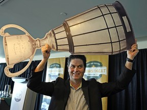 Duane Vienneau, executive director of the 2018 Grey Cup Festival, holds a mock Grey Cup over his head at an announcement for the 106th CFL Grey Cup Championship held at the Shaw Conference Centre on Friday. Tickets for the game go on sale to the general public on June 1, 2018.