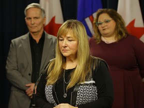 Alberta Health Minister Sarah Hoffman (right) held a news conference after introducing legislation that "would protect people seeking addiction and mental health services." She was joined by Mike Argent (left) and Kim Argent (middle), founders of Taylor Argent Legacy Foundation. (PHOTO BY LARRY WONG/POSTMEDIA)