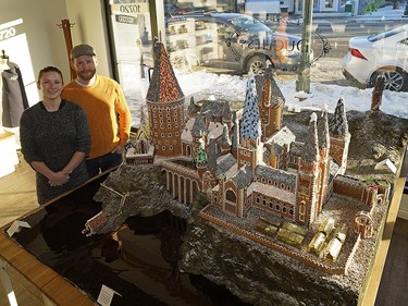 This year Duchess Bake Shop owners Garner Beggs (right) and wife Kelsey Johnson (left) constructed a 1:100 scale replica of Hogwarts Castle. It is based on the model built in England where the Harry Potter movies were filmed. They spent hundreds of hours building the edible gingerbread castle as a fundraiser for tbe Bissell Centre. Anyone dropping off a pair of socks can enter to win the castle. (PHOTO BY LARRY WONG/POSTMEDIA)
