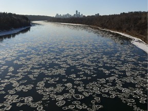 Pieces of ice drift down the North Saskatchewan river on a warm winter day on Wednesday, Nov. 28, 2018, in Edmonton.
