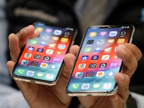 The iPhone XS, left, and XS Max are displayed side to side during an event to announce new products at Apple headquarters Wednesday, Sept. 12, 2018, in Cupertino, Calif.