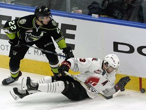 Edmonton Oil Kings Matthew Robertson, left, checks Moose Jaw Warriors Tristan Langan during WHL hockey game action in Edmonton on Friday, Nov. 30, 2018.