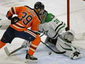 Dallas Stars goalie Anton Khudobin (right) makes a save on Edmonton Oilers winger Alex Chiasson (left) during first period NHL hockey game action in Edmonton on Tuesday November 27, 2018.