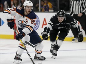 Edmonton Oilers center Connor McDavid (97) controls the puck with Los Angeles Kings left wing Austin Wagner (51) defending during the first period of an NHL hockey game in Los Angeles, Sunday, Nov. 25, 2018.