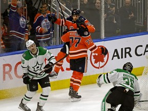 Edmonton Oilers defenceman Oscar Klefbom celebrates with team mate Leon Draisaitl after Klefbom scored in overtime against Dallas Stars goalie Anton Khudobin (right). Stars Jason Dickinson (left) skates away. The Oilers defeated the Stars by a score of 1-0 in NHL hockey game action in Edmonton on Tuesday November 27,2018. (PHOTO BY LARRY WONG/POSTMEDIA)