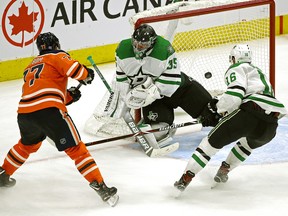 Edmonton Oilers defenceman Oscar Klefbom (left) scores in overtime against Dallas Stars goalie Anton Khudobin as Stars Jason Dickinson (right) watches the puck go into the net. The Oilers defeated the Stars by a score of 1-0 in NHL hockey game action in Edmonton on Tuesday November 27,2018. (PHOTO BY LARRY WONG/POSTMEDIA)