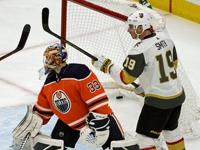 Edmonton Oilers goalie Cam Talbot and Vegas Golden Knights winger Reilly Smith look for the puck during second period NHL hockey game action in Edmonton on Sunday, Nov. 18, 2018.