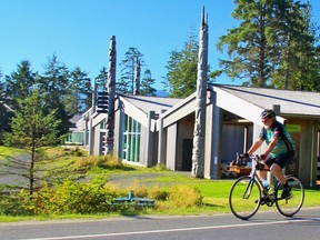 Edmonton Journal columnist Nick Lees cycles past the Haida Gwaii Museum in Skidegate, B.C., during a 2014 visit. Lees is inviting 20 cyclists to get pledges and participate in a CASA fund-raising cycling trip to Skidegate from Prince Rupert, B.C., next June 15-22.