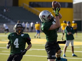 Lloydminster's Zach Desiatnyk (right), from Holy Rosary High School makes a catch as Peter Cho from Sherwood Park's Archbishop Jordan chases during the first day of Football Alberta's North Selection Camp for the 26th annual Senior Bowl High School Football All-Star Game at Foote Field at the University of Alberta in Edmonton, Alta., on Friday, April 10, 2015. File photo.