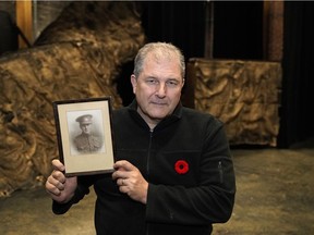 John Hudson, artistic director of Shadow Theatre, with a framed photograph of his great uncle Wilson Hatfield, who died at the Battle of the Somme in 1916.