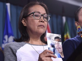 Debbie Baptiste, mother of Colten Boushie, holds a photo of her son during a press conference on Parliament Hill in Ottawa on February 14, 2018.