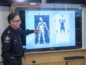 Ken Johnston, the director of security at the Edmonton Remand Centre, shows how drugs in a body cavity appear on the scanned image in this file photo from October 2017. Photo by Shaughn Butts / Postmedia