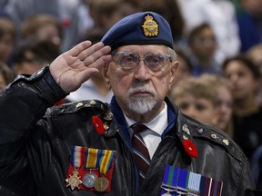 Royal Air Force veteran Jack Jamieson salutes as he takes part in a Remembrance Day ceremony at Vimy Ridge School in Edmonton on Friday November 9, 2018. (Photo by David Bloom)
