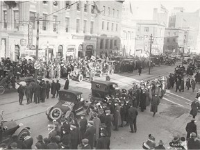 Edmontonians celebrating the end of the Great War took to the streets with cheesecloth masks for protection from the Spanish Flu. This photo shows the scene at Jasper Avenue and 101 Street.