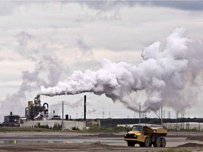 A dump truck works near the Syncrude oil sands extraction facility near the city of Fort McMurray. File photo.