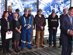 Premier Rachel Notley (L) standing with workers waiting to speak on seeking industry interest in oil refining from the private sector at a news conference in Edmonton, December 11, 2018. Ed Kaiser/Postmedia