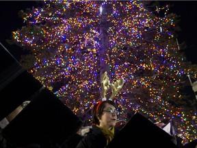 Members of the Chronos Vocal Ensemble sing Christmas carols during the officially light up of the Downtown Business Association's Christmas Tree in Churchill Square, in Edmonton Friday Nov. 16, 2018. The 20 metre tall white spruce tree weighs close to 2800 kg. Photo by David Bloom