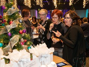 People bid on silent auction items during the Festival of Trees luncheon gala at the Shaw Conference Centre in Edmonton on Nov. 30, 2018.