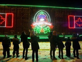 Edmontonians watch as the CP Holiday Train arrives at the Old Strathcona CP yard, 103 Street and 80 Ave., Monday Dec. 10, 2018.