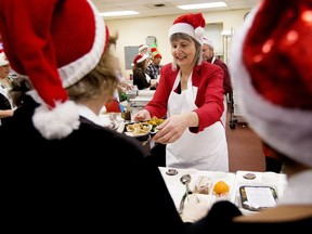 Volunteers take part in the annual Christmas With Friends event at Edmonton Meals On Wheels, 11111 103 Ave., in Edmonton on Wednesday, Dec. 19, 2018. During the event 40 special guest volunteers, made up of large donors, funders, and elected officials, helped make 245 meals.