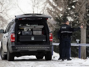 Police and emergency crews in a field behind Queen Elizabeth School, 9425 132 Ave., in Edmonton on Sunday, Dec. 23, 2018 after a deceased man was discovered.