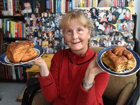 Surrounded by photos of friends and staff from the Highlevel Diner, Kim Franklin poses at home with the restaurant's legendary cinnamon buns.