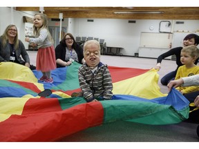 Porter Stanley takes part in the parachute game at preschool in Onoway, Alta., on Wednesday, November 7, 2018. Porter Stanley is one of 30 people in the world to be diagnosed with Beare-Stevenson syndrome, a craniofacial disorder.