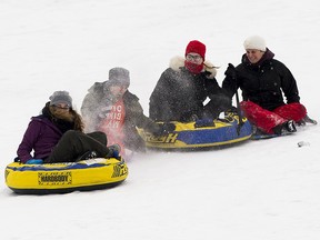 Nina Jacob, right, has some family fun with family friend Korlee Toews, and her children, Jeremy Buck and Amber Buck on Cloverdale hill,Tuesday, Dec. 25, 2018 in Edmonton.  (Greg Southam-Postmedia) ORG XMIT: POS1812251520127349