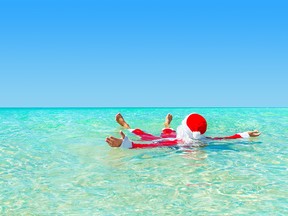 Santa Claus take pleasure swimming  in ocean water.