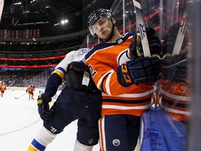 St. Louis Blues' Oskar Sundqvist (70) checks Edmonton Oilers' Caleb Jones (82) during third period NHL action in Edmonton, Alta., on Tuesday December 18, 2018. THE CANADIAN PRESS/Jason Franson ORG XMIT: EDM120