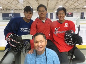 Fifteen-year-old Fareez Afdlin, left, Alvin Chan and Josh Chan, 14, helped the Singapore hockey club at the recent Southeast Asian Youth Games. In front is Michael Chan, a badminton pro at the Royal Glenora Cub for 34 years.