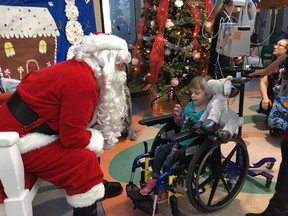 Stollery Childrenís Hospital patients meet with Santa during a visit to the hospital on Dec. 13, 2018. Santa was escorted to the hospital by the Edmonton Garrisonís 408 Tactical Helicopter Squadron where squadron personnel donated more than $1,000 to purchase more than 100 teddy bears for the children.  (Photo by Clare Rayment/Postmedia)