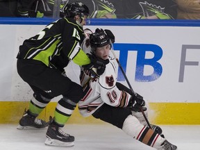 Edmonton Oil Kings Scott Atkinson (15) holds onto Calgary Hitmen Josh Prokop during first period WHL action on Saturday, Dec. 15, 2018, in Edmonton.