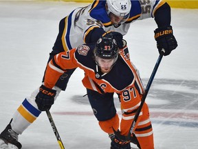 Edmonton Oilers Connor McDavid (97) gets hooked on his arm by St. Louis Blues Colton Parayko (55) in NHL action at Rogers Place in Edmonton, December 18, 2018.