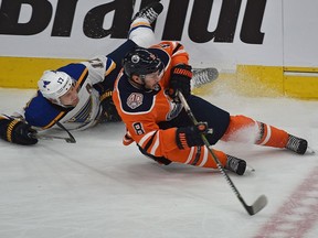 Edmonton Oilers Ty Rattie (8) loses his edge while battling for the puck with St. Louis Blues Jaden Schwartz (17) in NHL action at Rogers Place in Edmonton on Tuesday, Dec. 18, 2018.