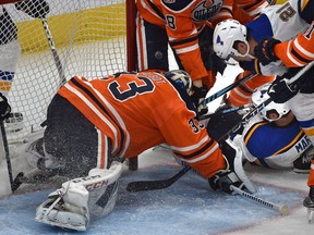 After a lengthy video review, Edmonton Oilers goalie Cam Talbot (33) seems to drag the puck with his pad over the goal line giving the St. Louis Blues goal scored by Patrick Maroon (7) lying on the ice in NHL action at Rogers Place in Edmonton, December 18, 2018. Ed Kaiser/Postmedia