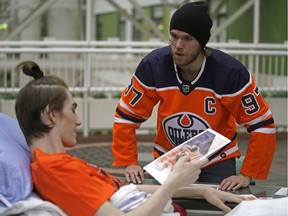Edmonton Oilers captain Connor McDavid chats with patient Cole Golson at the Stollery Children's Hospital in Edmonton on Friday Dec. 21, 2018, where he and some team members paid a visit and signed autographs.