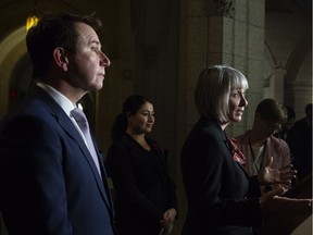 Status of Women Minister Maryam Monsef and Treasury Board President and Digital Government Minister Scott Brison look on as Employment, Workforce Development and Labour Minister Patricia Hajdu speaks during a pay equity announcement in Ottawa, Monday October 29, 2018.