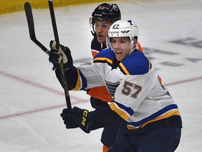 St. Louis Blues David Perron (57) in front of Edmonton Oilers Caleb Jones (82) in NHL action at Rogers Place in Edmonton, December 18, 2018. Ed Kaiser/Postmedia