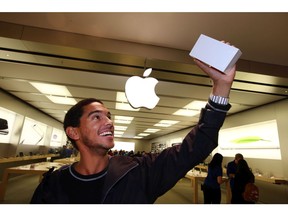Jesse Letain shows his new iPhone at the Southgate Apple Store In Edmonton. File photo.
