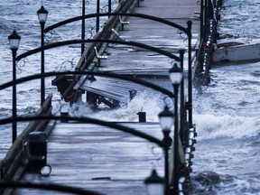 A boat is battered by waves and slammed into the White Rock Pier that was severely damaged during a windstorm, in White Rock, B.C., on Thursday December 20, 2018. One person who was trapped on the pier had to be rescued by helicopter.