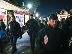 (FILES) In this file photo taken on November 23, 2018 French policemen of the CRS company patrol in Strasbourg, eastern France, on the opening day of the city's Christmas market, the largest and one of the oldest Christmas markets in France. - One person has been killed and six people injured in a shooting near a Christmas market in the eastern French city of Strasbourg on December 11, 2018, police said, adding that the suspect was on the run.