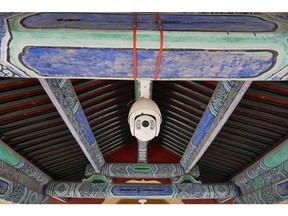 Experts estimate China spends more on artificial intelligence around surveillance — like these cameras at the Temple of Heaven Park in Beijing — than any other area.